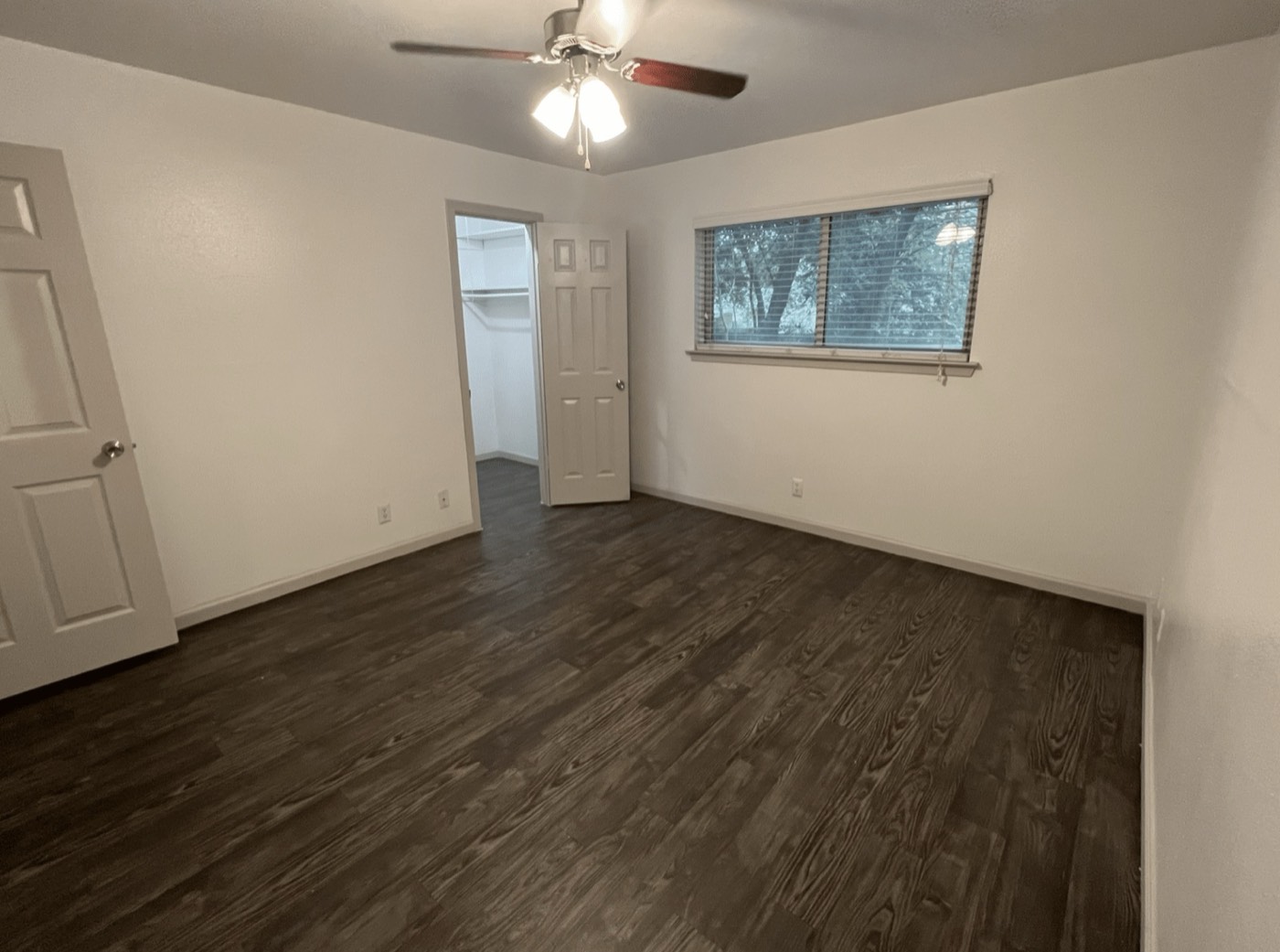 Bedroom with ceiling fan and wood-style flooring